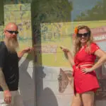 Matt and Amy of the Peddler's Post posing in front of the mural at Floral City Hardware, Floral City, FL.