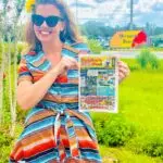 Amy of the Peddler's Post in Hernando County Photo Shoo in front of the Hernando Beach, FL sign