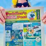 Amy of the Peddler's Post in Hernando County Photo Shoot. Hernando Beach, FL. at Pine Island holding up a copy of the Peddler's Post