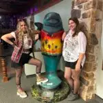 Amy of the Peddler's Post posing with friend at the 80's night at the Ellie Schiller Homosassa Springs State Wildlife Park with the Twistid Arts Initiative July 2023.