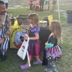 Chris helping kids play the Penny Plinko game at the 4th Annual Monster Car Show with the Boys and Girls Club of Hernando County.2023