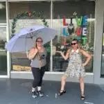 Amy and Stephanie our July 2023 Hernando County Umbrella Winner posing outside of Guns and Buns in Brooksville FL