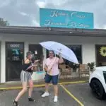 Amy posing with Gaye our October 2023 Citrus County Umbrella Winner in front of the Nature Coast Furniture Boutique in Homosassa Springs FL