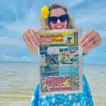 Amy of the Peddler's Post in Hernando County Photo Shoot. Hernando Beach, FL. at Pine Island. holding up a magazine