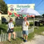 Amy posing with Pete our September 2023 Citrus County Umbrella Winner out front of Hernando Fresh Market in Hernando FL