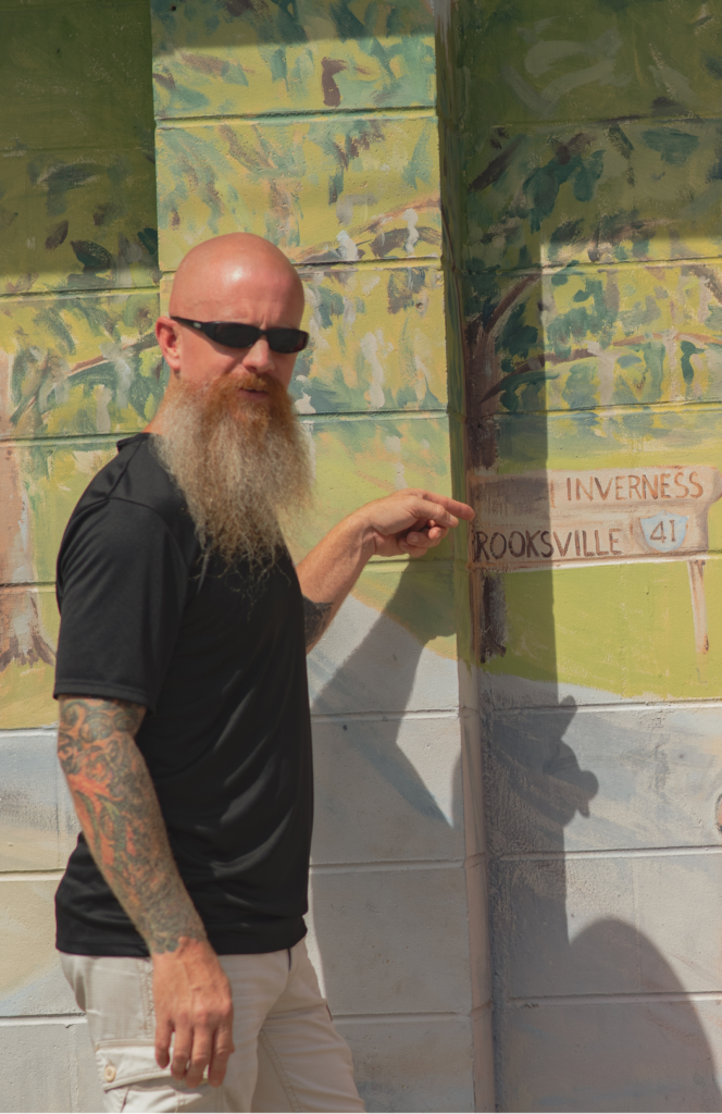 Matt of the Peddlers Post Poses for a Picture outside of Floral City Hardware in Floral City, FL